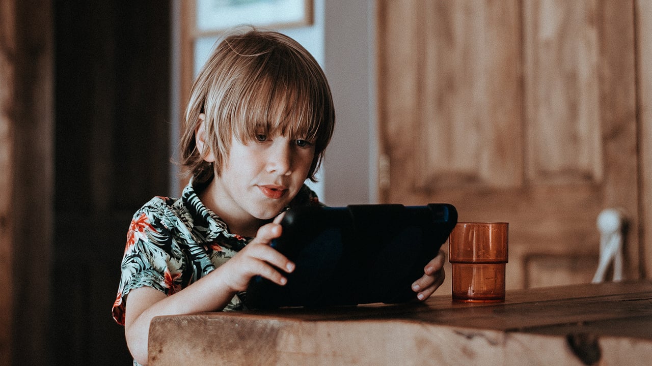 child looking at tablet