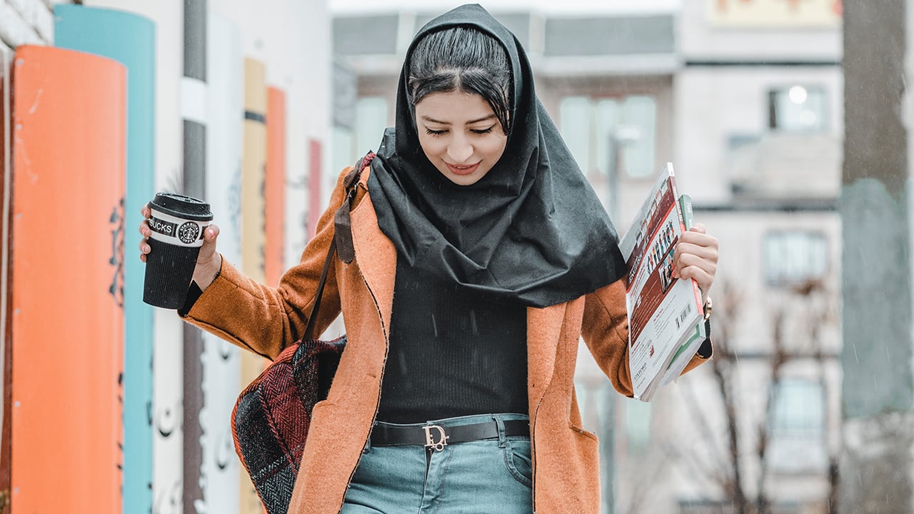 girl holding books