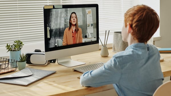 photo-of-child-sitting-by-the-table-while-looking-at-the-computer