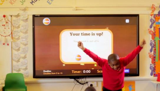 kid using touchscreen technology in classroom